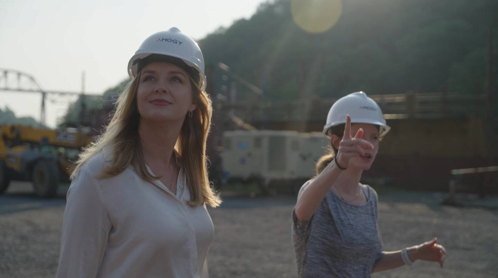 Women wearing construction hats walking around